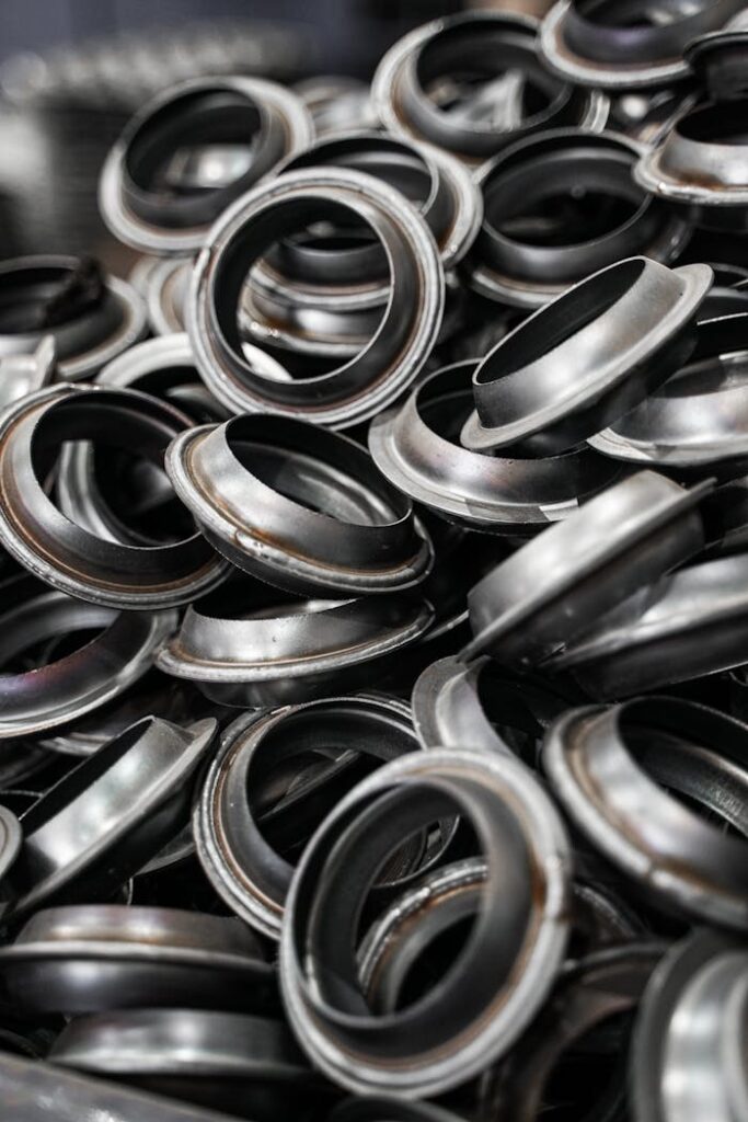 pexels photo 12951626 A detailed shot of metal flanges piled together, showcasing industrial precision.