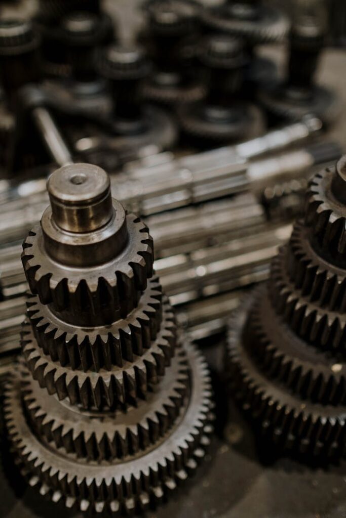pexels photo 7568421 Close-up view of stacked metal gears in a workshop, highlighting precision engineering.