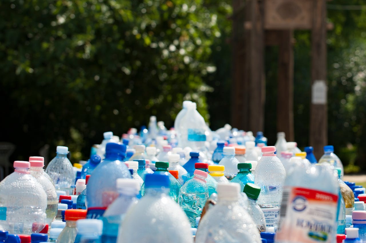creative-02 A vibrant collection of plastic bottles in an outdoor recycling setup, showcasing environmental awareness.